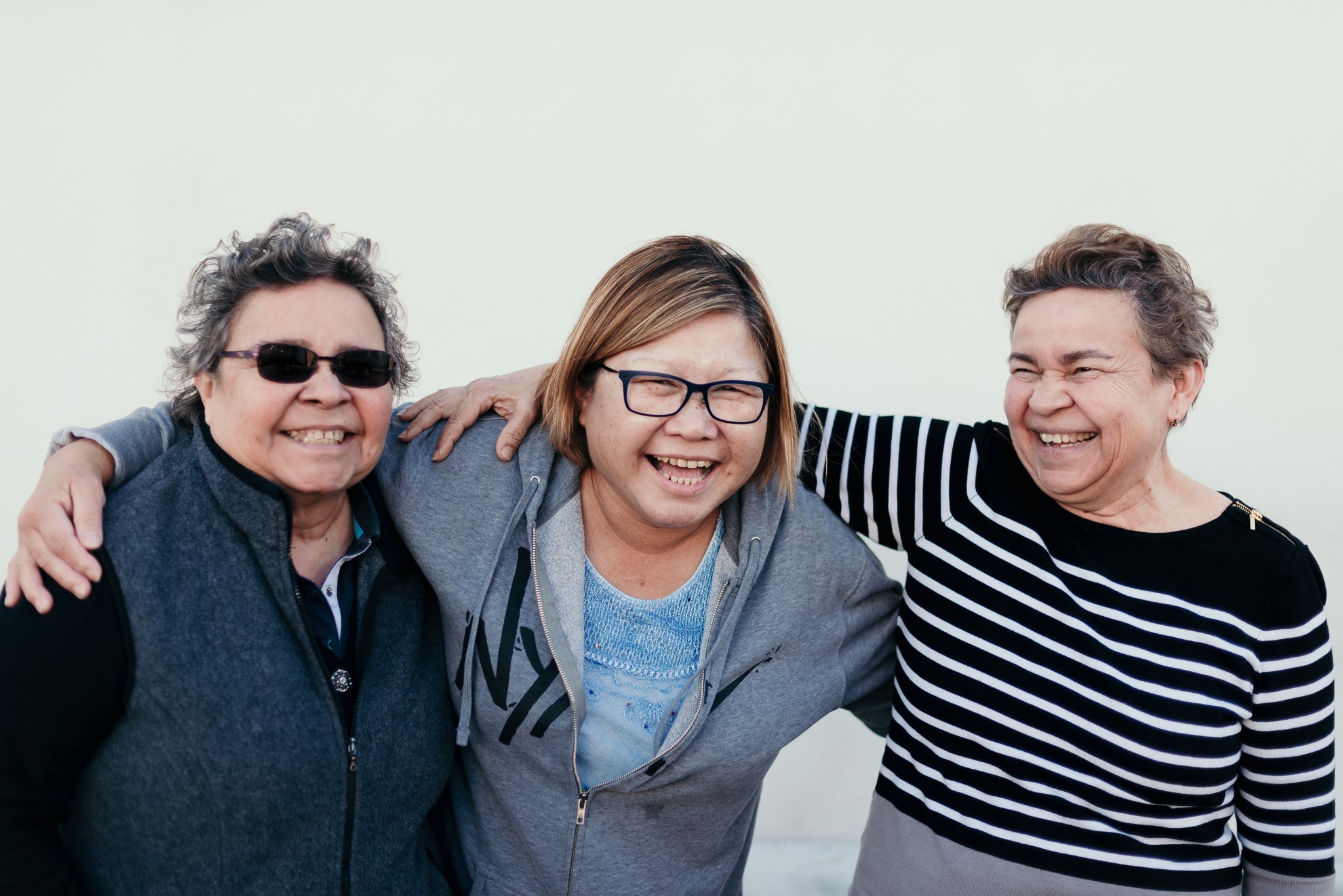 Three women smiling together